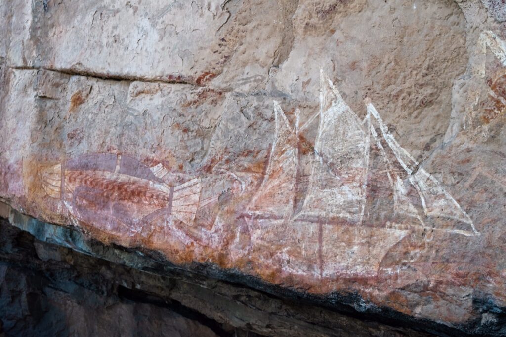 Australian Aboriginal rock art of a ship, fish, and other figures
