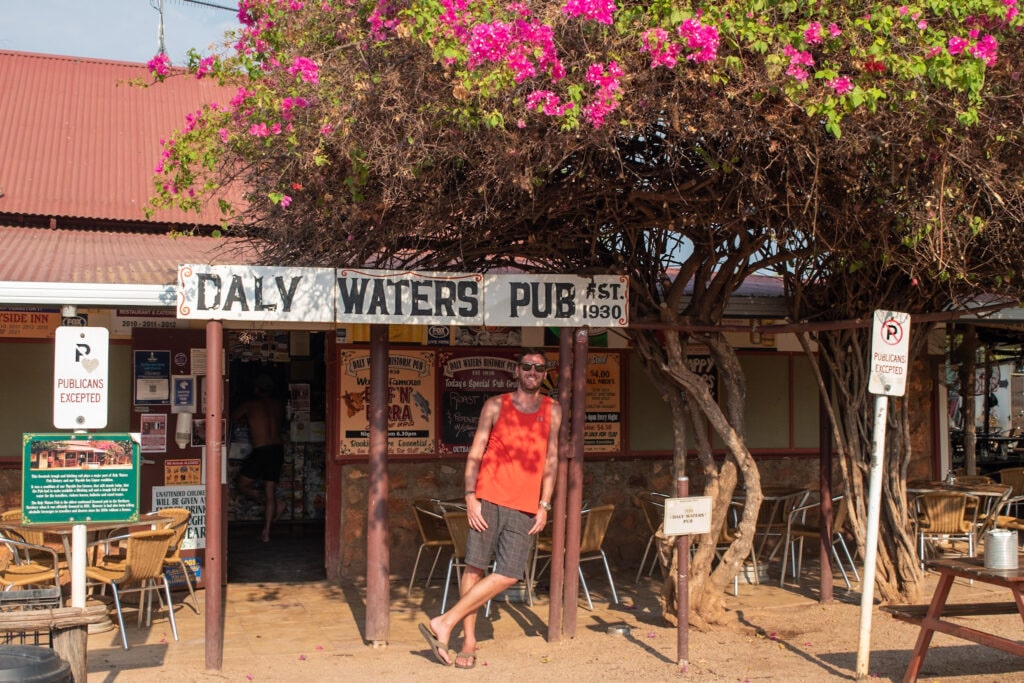 A man stands outside Daly Waters Pub, a classic Outback Australian pub