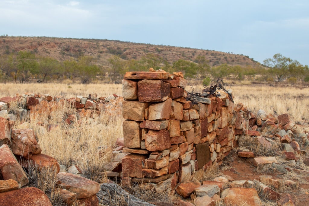 Brick ruins among dry grasslands and low hills