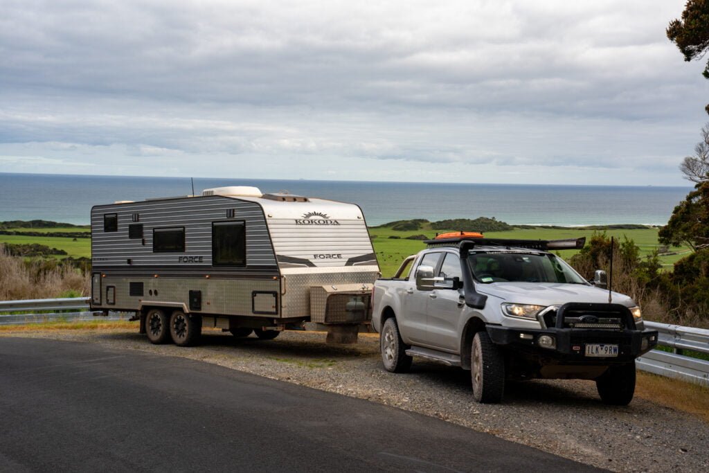 A car and a caravan are pulled over on the side of a road