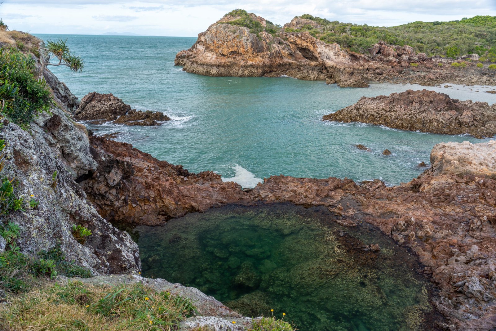 A few from above a rockpool looking out onto the ocean and a rocky outcrop in the distance
